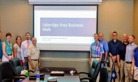 People gathered in a board room for the Lakeridge Area Business Walk